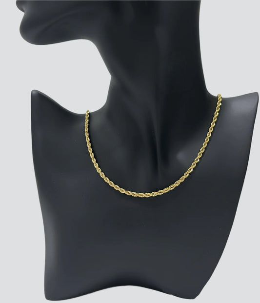 a gold rope chain necklace displayed around on a matte black mannequin bust. the background is plain gray.