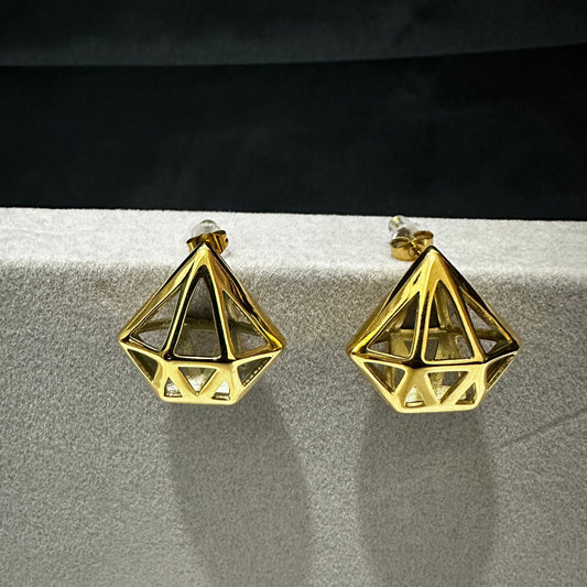 A pair of Geometric Gold earrings with triangular cutouts is displayed against a neutral background.