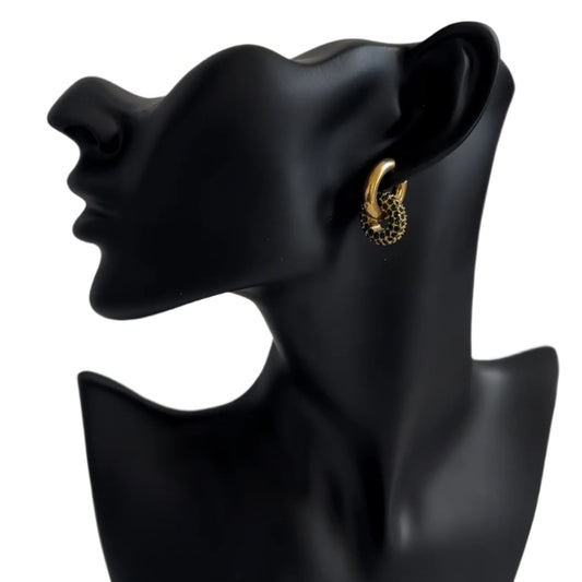 A black mannequin head displaying a gold hoop earring with lvzuan gemstones arranged in a circular pattern near the earlobe. The background is neutral, emphasizing the contrast between the gold metal and the lvzuan gems.